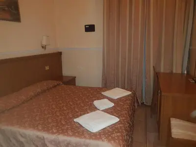 a bedroom with a bed with two towels on it at Hotel Aristotele in Rome