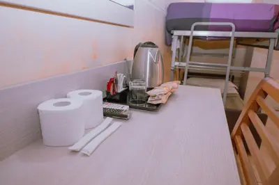a table in a room with a bunk bed at Hotel Aristotele in Rome