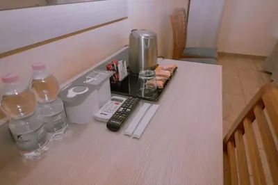 a table with a coffee maker and drinks on it at Hotel Aristotele in Rome
