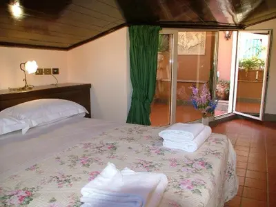 a bedroom with a bed with towels on it at Hotel OKAPI in Rome