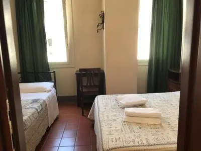 a hotel room with two beds with towels on them at Hotel OKAPI in Rome