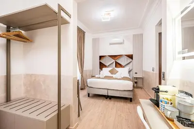 a hotel room with a bed and a kitchen at Cola Di Rienzo Suite Guest House in Rome