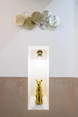 a statue of a dog on a shelf with a mirror at Cola Di Rienzo Suite Guest House in Rome