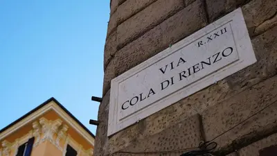 a sign on the side of a brick building at Cola Di Rienzo Suite Guest House in Rome