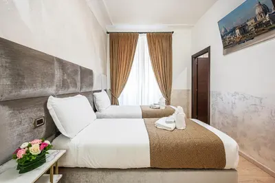 a hotel room with two beds and a window at Cola Di Rienzo Suite Guest House in Rome
