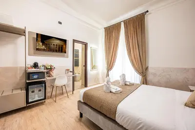 two beds in a hotel room with towels on them at Cola Di Rienzo Suite Guest House in Rome
