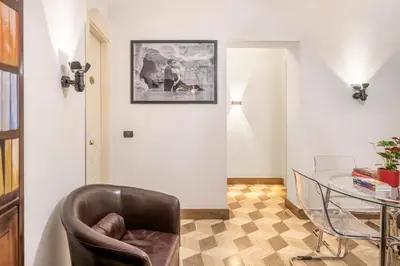 a room with a chair and a glass table at The Five Oscars Inn in Rome