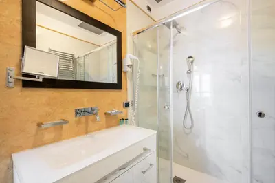 a bathroom with a shower and a sink and a mirror at The Five Oscars Inn in Rome