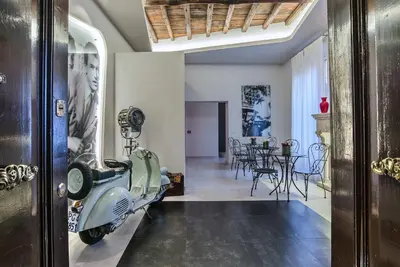 a vespa parked in a hallway with a dining room at Via Veneto Prestige Rooms in Rome