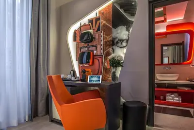 a room with a desk with a chair and a mirror at Via Veneto Prestige Rooms in Rome