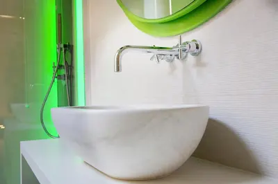 a white sink in a bathroom with a mirror at Via Veneto Prestige Rooms in Rome
