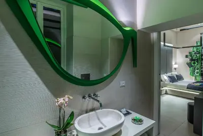 a bathroom with a sink and a mirror at Via Veneto Prestige Rooms in Rome