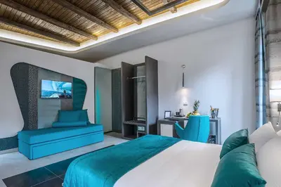 a bedroom with a large bed and a desk at Via Veneto Prestige Rooms in Rome