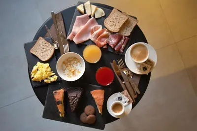 a plate of breakfast foods and coffee on a table at Via Veneto Prestige Rooms in Rome