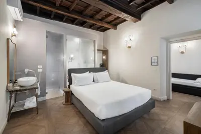 a hotel room with a bed and a bathroom at 59 Steps Trevi in Rome