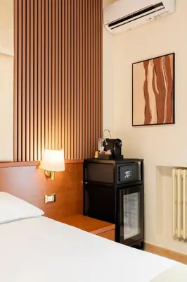 a bedroom with a bed and a lamp next to a bed at AlbaDomus Affittacamere o GuestHouse in Rome
