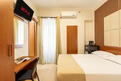 a hotel room with a bed and a desk at AlbaDomus Affittacamere o GuestHouse in Rome