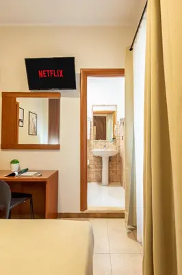 a hotel room with a bed and a bathroom at AlbaDomus Affittacamere o GuestHouse in Rome
