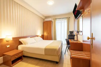 a hotel room with a bed and a desk at AlbaDomus Affittacamere o GuestHouse in Rome
