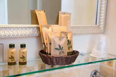 a basket ofentedented items on a counter in a bathroom at Hotel Arco Di Travertino in Rome