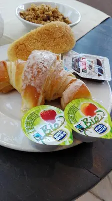 a plate of food with bread and eggs on it at Hotel Arco Di Travertino in Rome