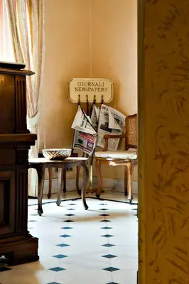 a room with chairs and a table and a sign at Hotel Arco Di Travertino in Rome