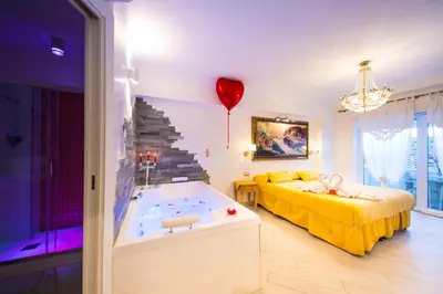 a room with a bed and a tub with a balloon at Suites Roma Tiburtina Elegance in Rome