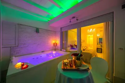 a bathroom with a tub with purple and green lights at Suites Roma Tiburtina Elegance in Rome