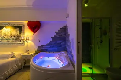 a bathroom with a tub with a staircase with a red balloon at Suites Roma Tiburtina Elegance in Rome