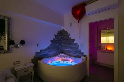 a room with a jacuzzi tub in a room with a balloon at Suites Roma Tiburtina Elegance in Rome