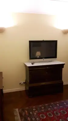 a flat screen tv sitting on top of a dresser at Giulio Caesar in Rome