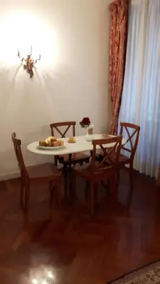 a table and chairs with a plate of food on it at Giulio Caesar in Rome