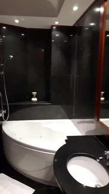 a bathroom with a white toilet with a black lid at Giulio Caesar in Rome