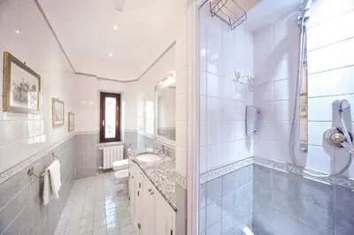 a white bathroom with a sink and a shower at Central Domus Roma in Rome