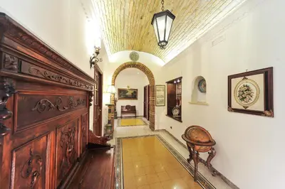 a white bathroom with a sink and a mirror at Central Domus Roma in Rome