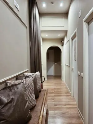 a living room with a couch and a hallway at Residenza Sciarra Suites in Rome