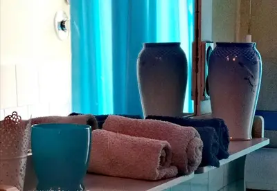 a shelf with three vases and towels on it at Suite 59 romeholidayhome in Rome