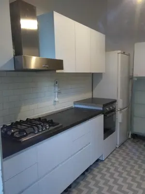 a kitchen with white cabinets and a stove top oven at Suite 59 romeholidayhome in Rome