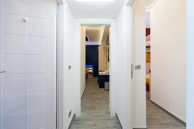 a hallway with white walls and tile floors at Guesthouse Pop in Rome