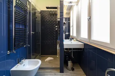 a bathroom with a sink and a toilet and a shower at Guesthouse Pop in Rome