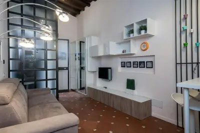 a living room with a couch and a tv at Margana Suite in Rome