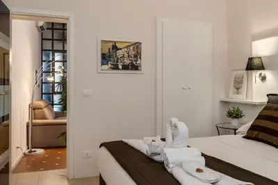 a bedroom with a bed with towels on it at Margana Suite in Rome