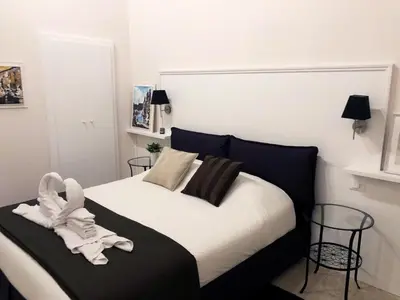 a bedroom with a bed with a towel on it at Margana Suite in Rome