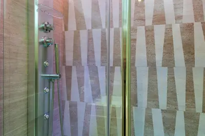 a shower with a glass door in a bathroom at Margana Suite in Rome