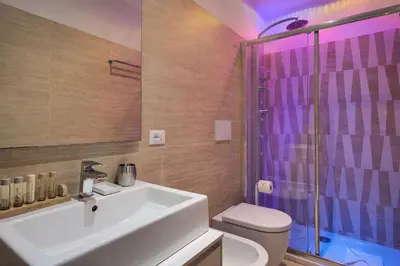 a bathroom with a sink and a shower and a toilet at Margana Suite in Rome