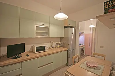 a kitchen with a table with a computer on it at Casa di Angela in Rome