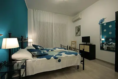 a bedroom with a bed and a table and a television at Casa di Angela in Rome