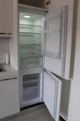 an empty refrigerator with its door open in a kitchen at Le Bellezze Vaticane in Rome