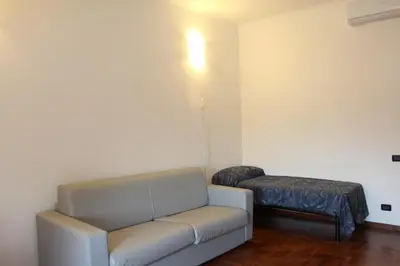 a living room with a couch and a stool at Le Bellezze Vaticane in Rome