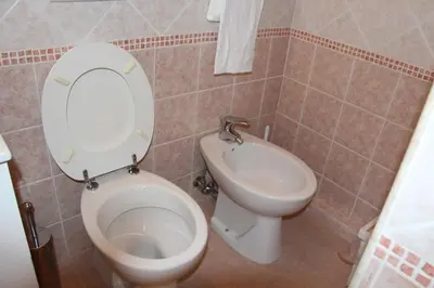 a bathroom with a toilet and a bidet at Le Bellezze Vaticane in Rome